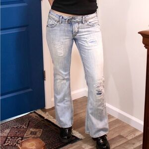 Silver Jeans light blue wash distressed bootcut jeans and a low rise fit